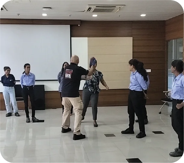 Live self-defence demonstration with women observing practical safety techniques